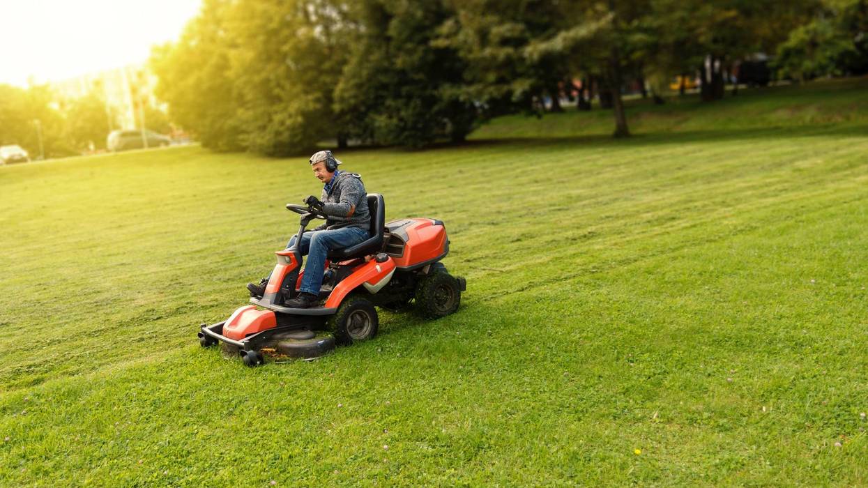 man drives a lawnmower