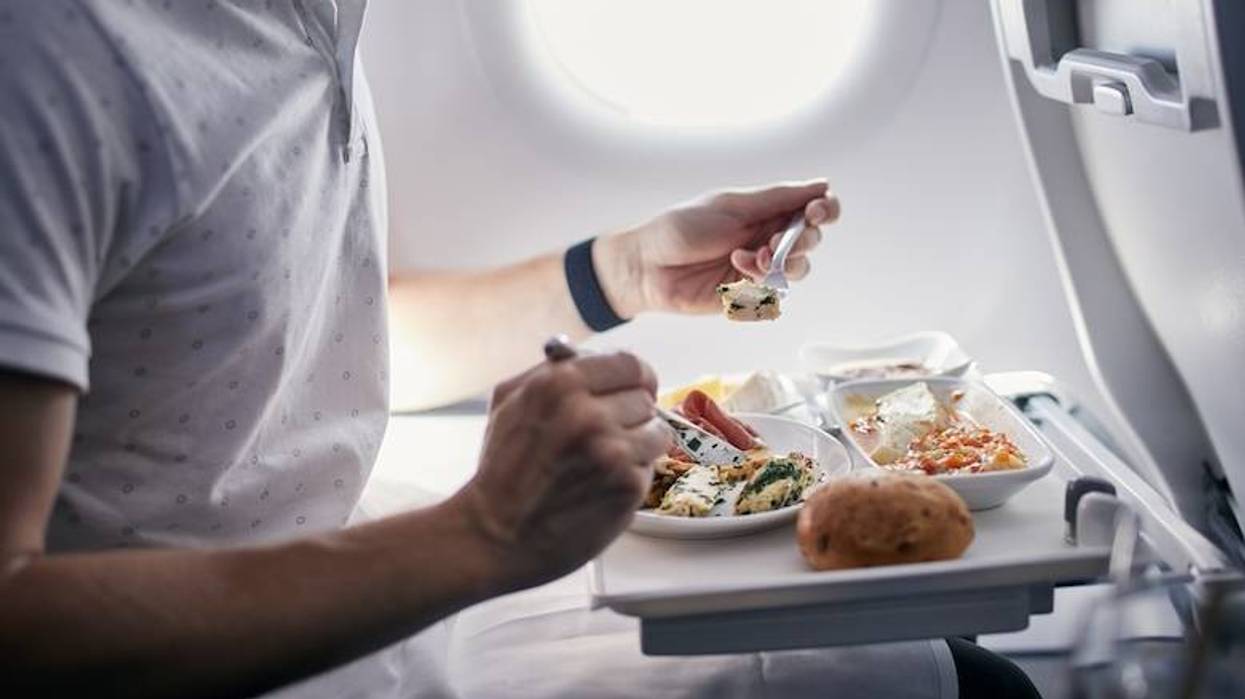 Man eating a meal on an airplane