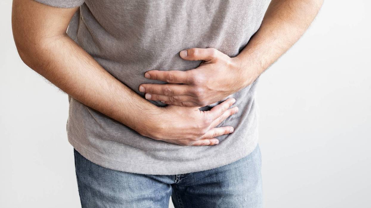 Man feeling abdominal pain and stomachache, a representation of digestive discomfort.