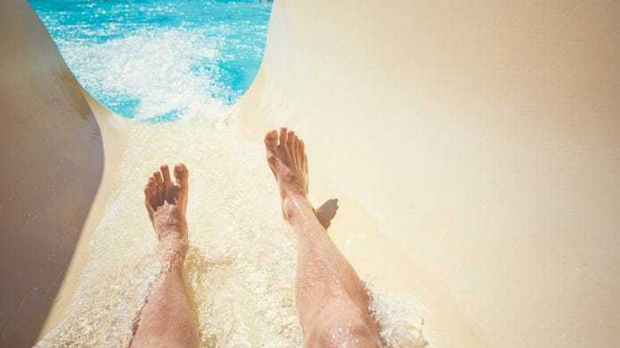 Man going down slide at waterpark