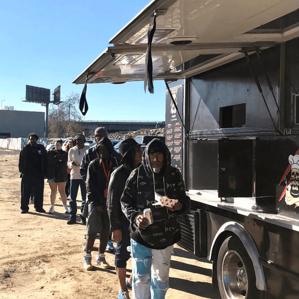 Man grabbing food from Savage Tacos in Long Beach.