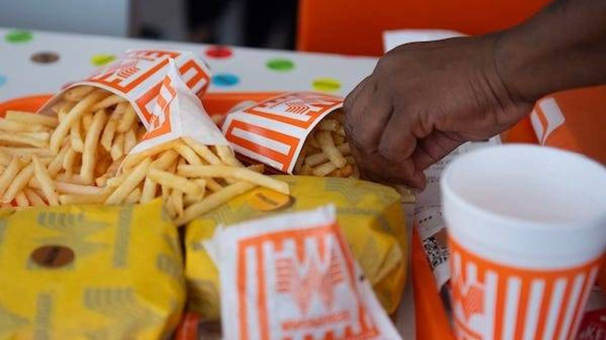 Man grabbing Whataburger french fries and hamburgers