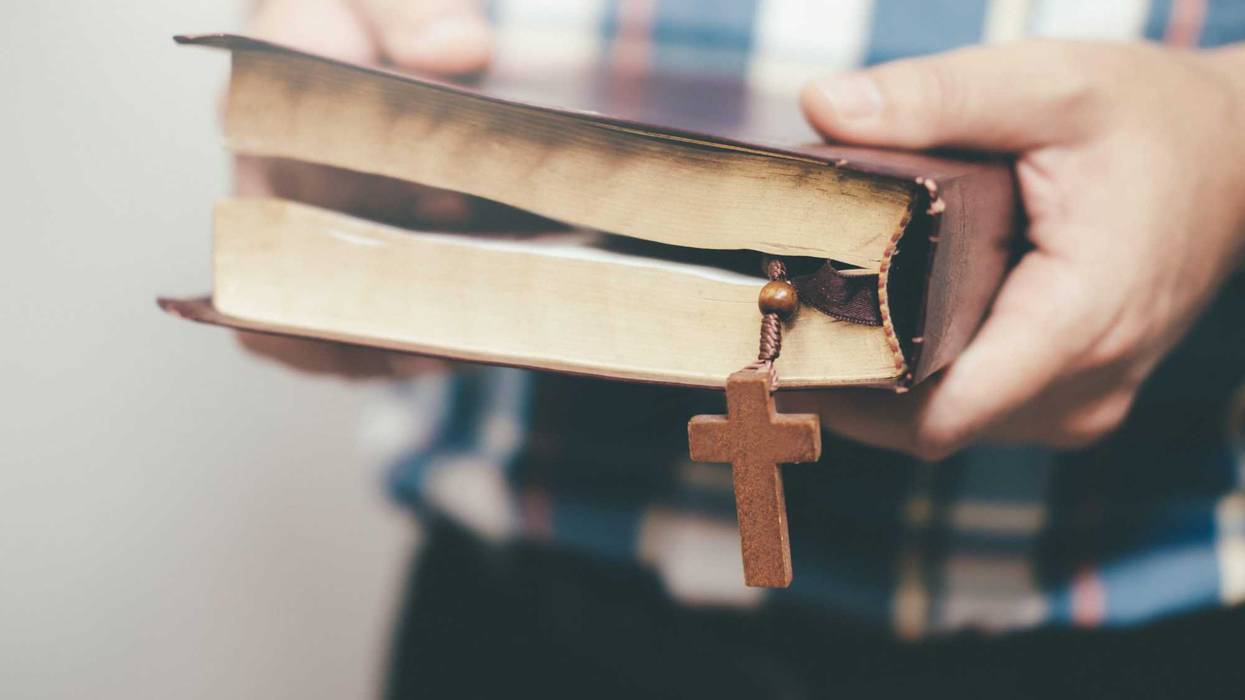 Man holding and reading the holy Christian Bible.