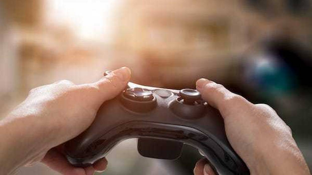 Man holding controller playing video games