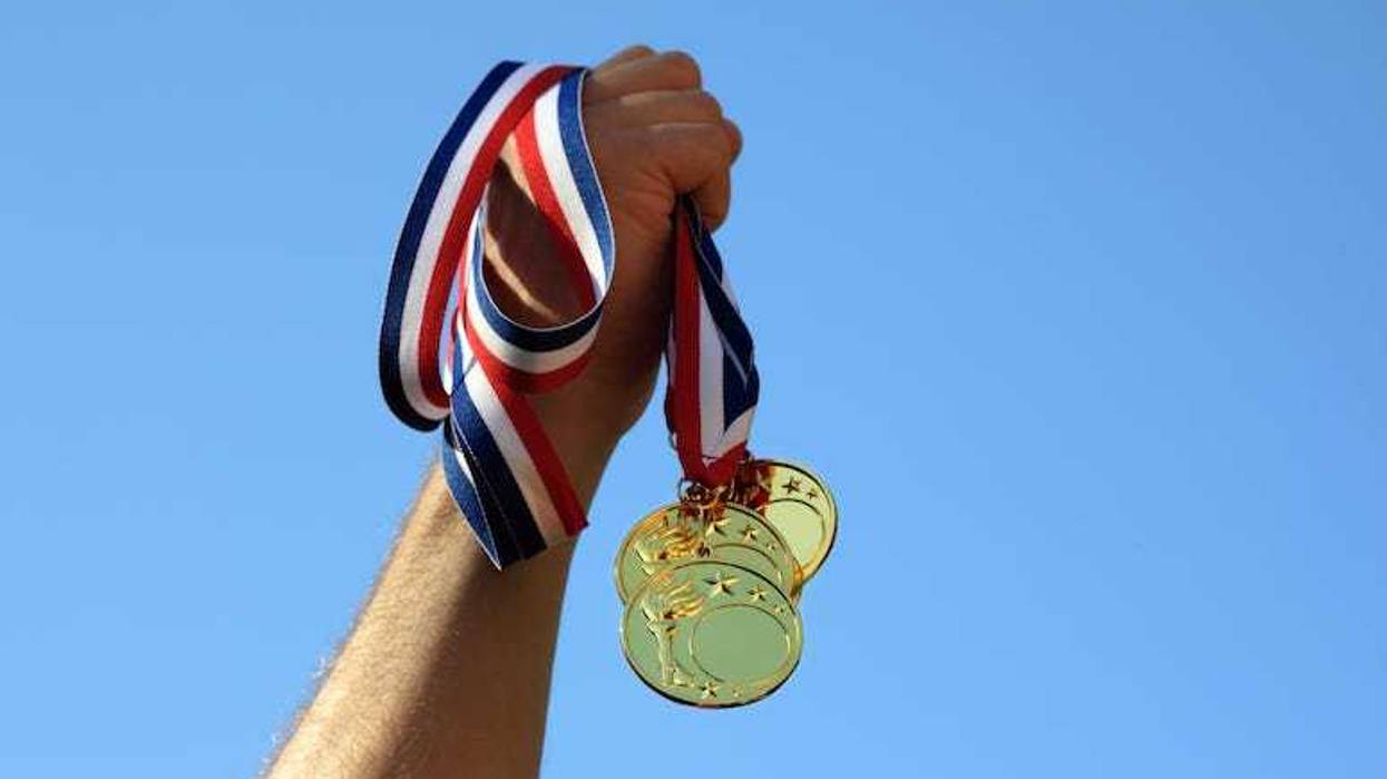 Man holding gold medals