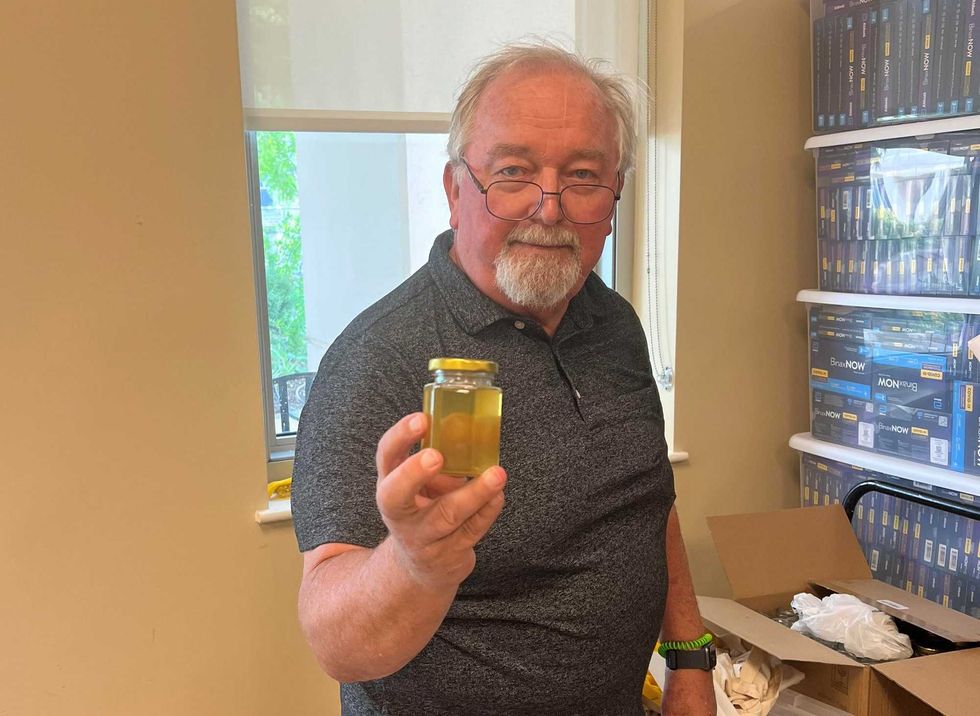 man holding honey jar