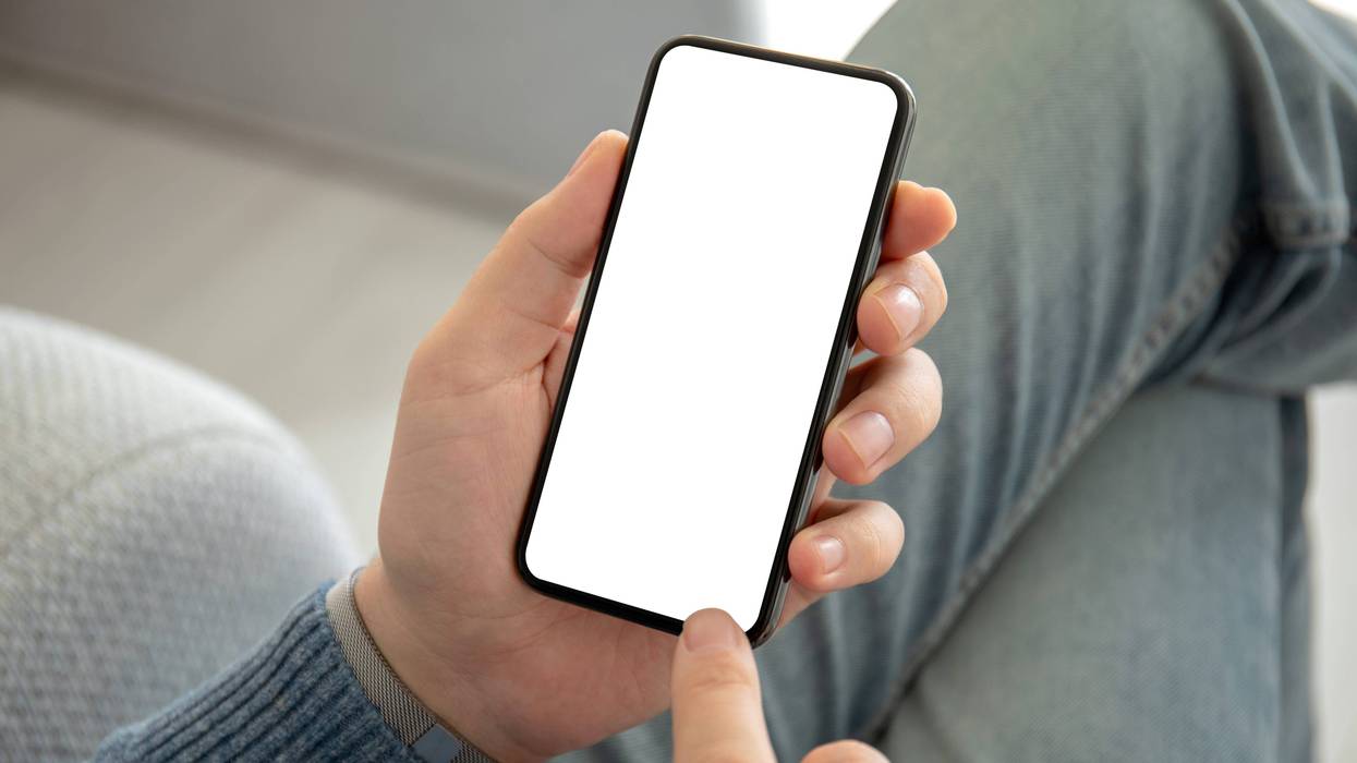 man holding phone with an isolated screen
