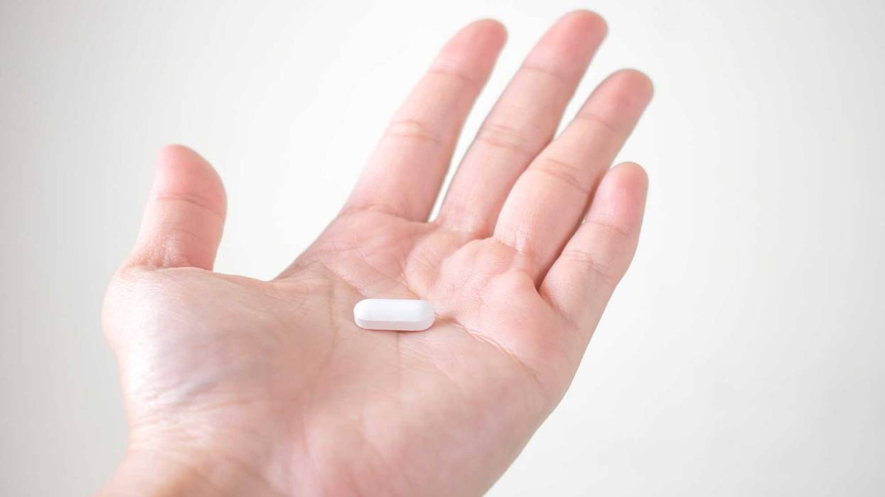 Man holding pill stock photo.