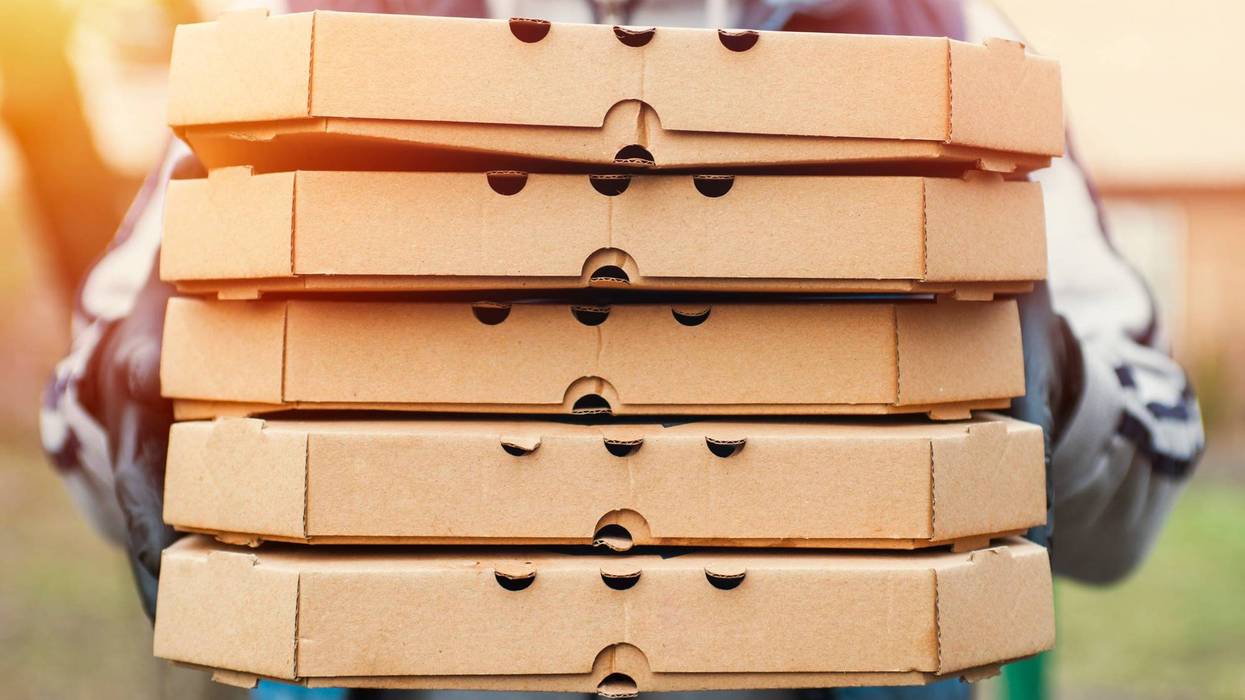 Man holding pizza boxes