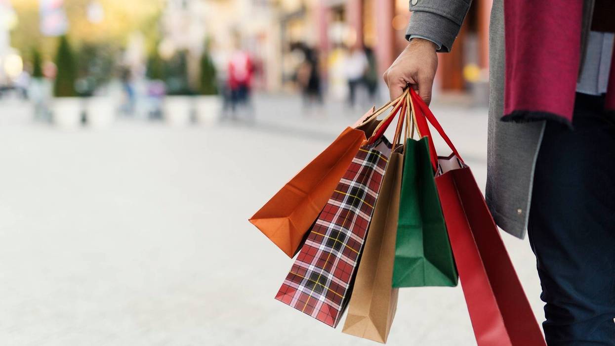 Man holding shopping bags with presents on the street