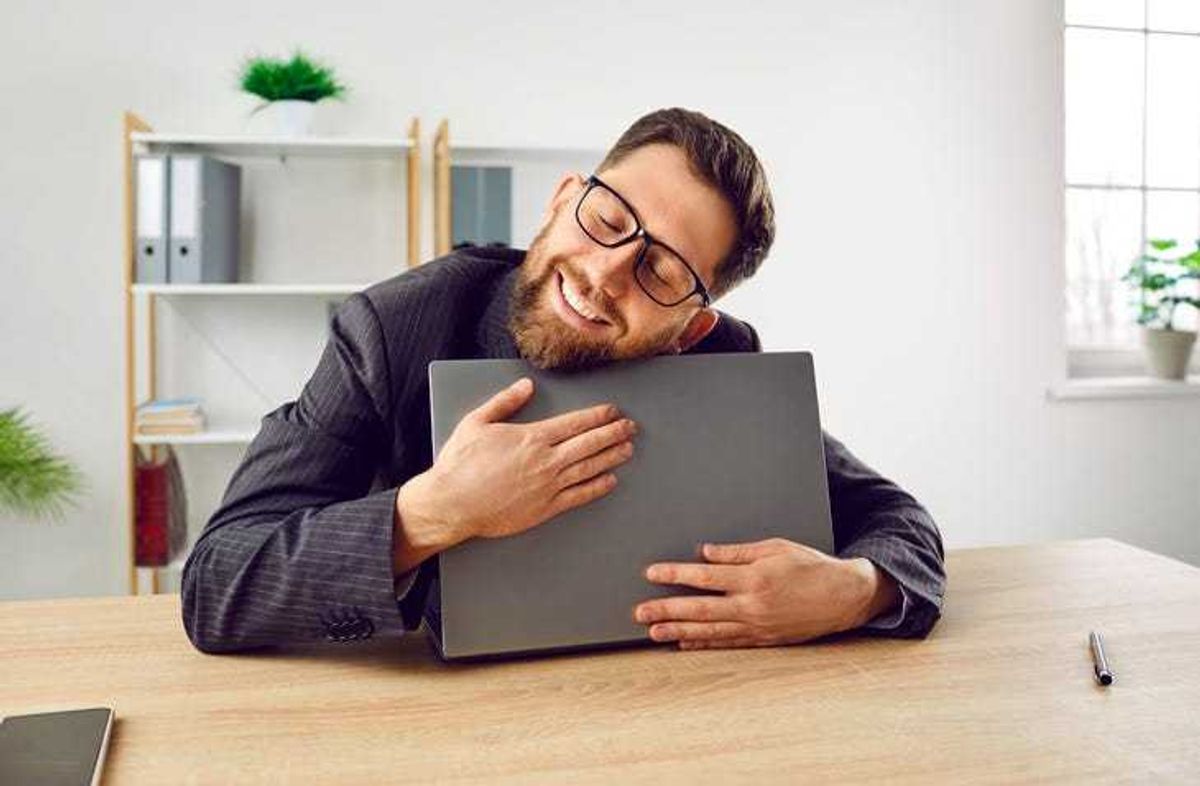 man hugging computer