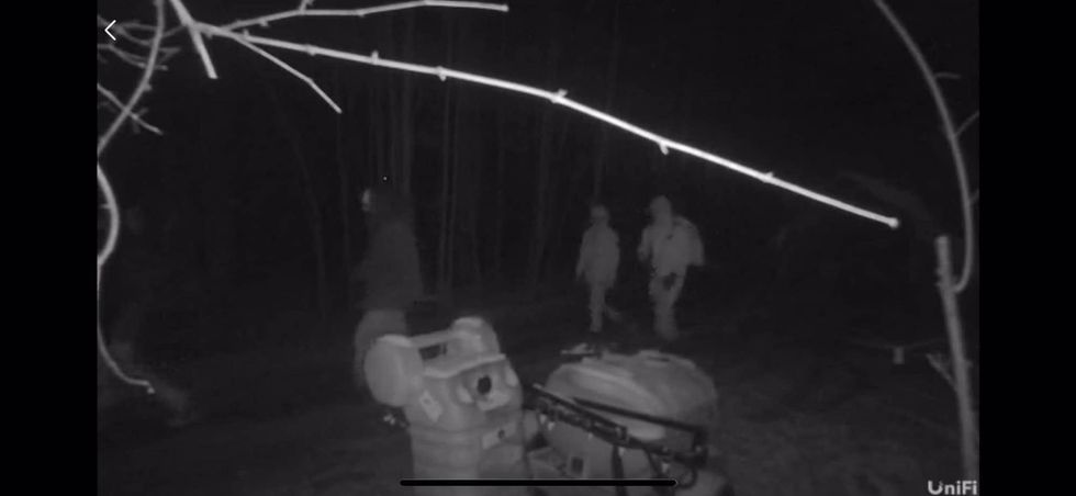 Man in all white on security camera