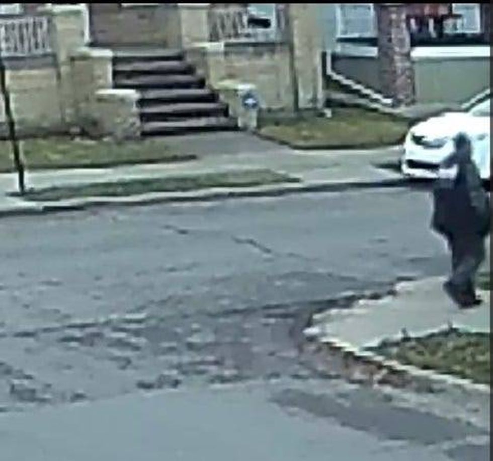 Man in sweatsuit walking down the street