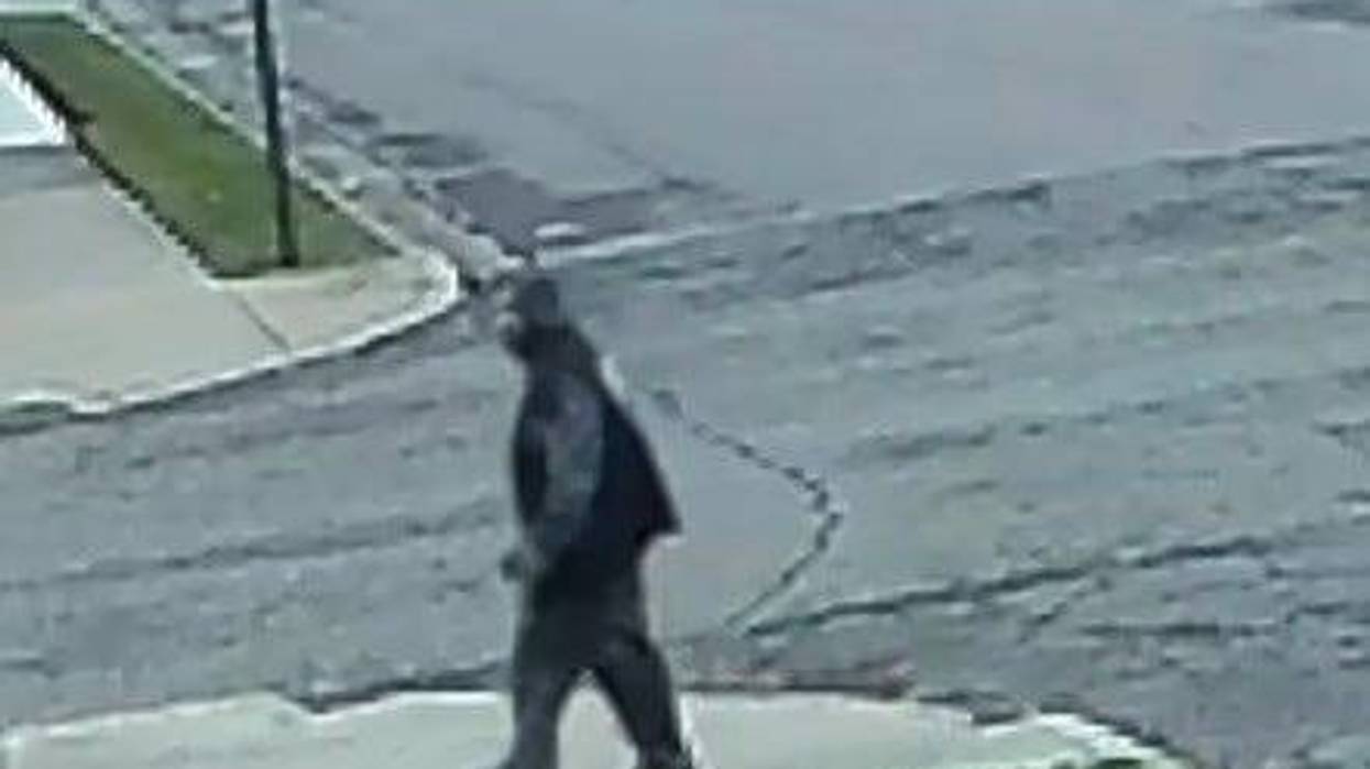 Man in sweatsuit walking down the street