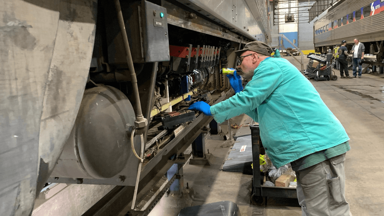 Man inspects one of SEPTA's 223 Silverliner IV rail cars