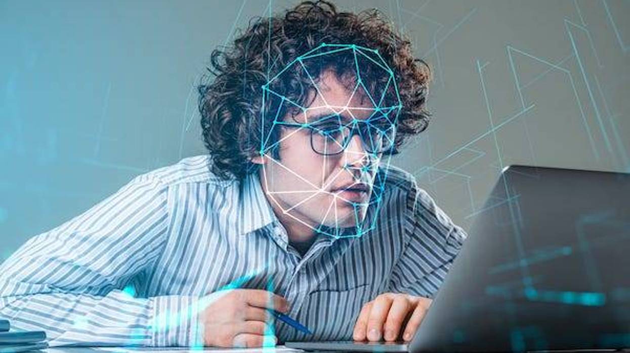 Man on a computer using facial recognition