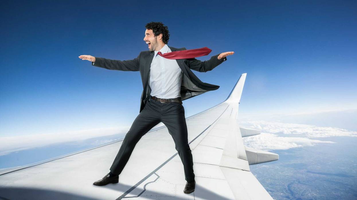 Man on plane wing stock photo.