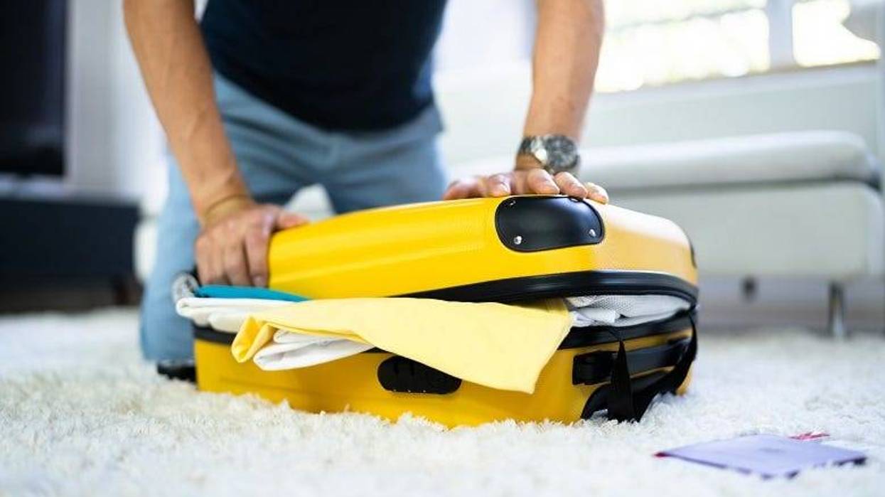 man packing suitcase