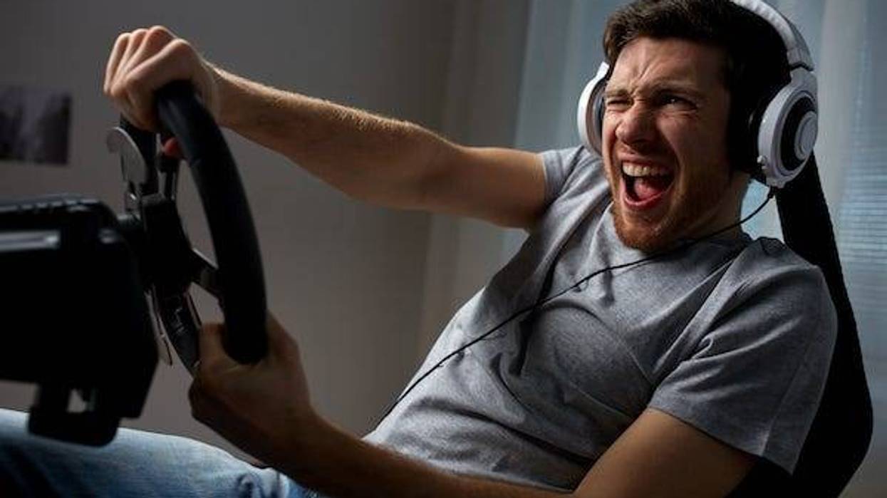 Man playing racing video game at home