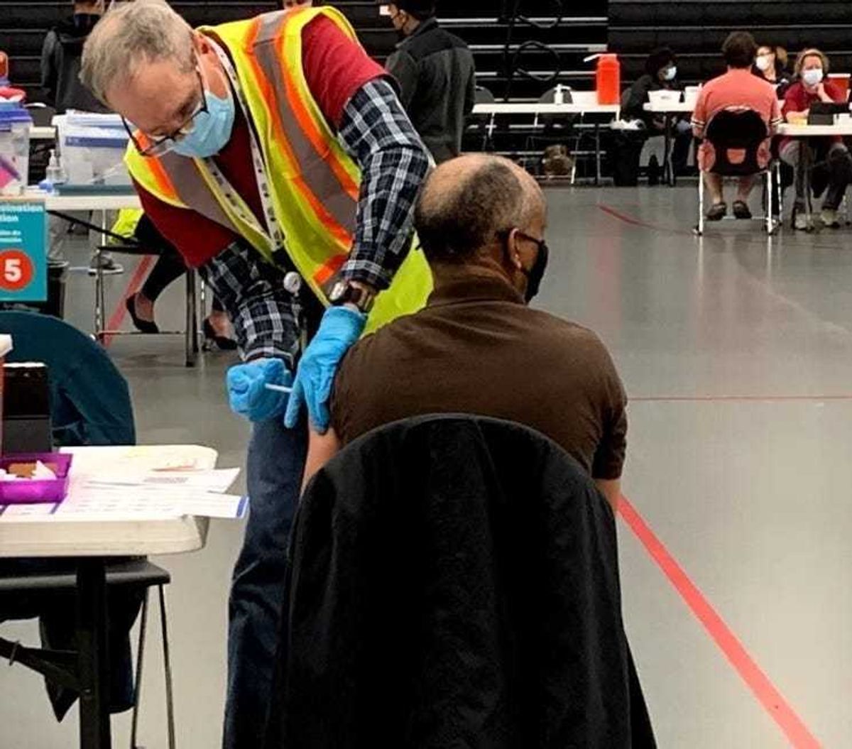 Man receives a vaccine shot in South Richmond