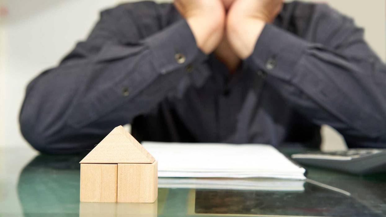 man sad with house loan bankruptcy