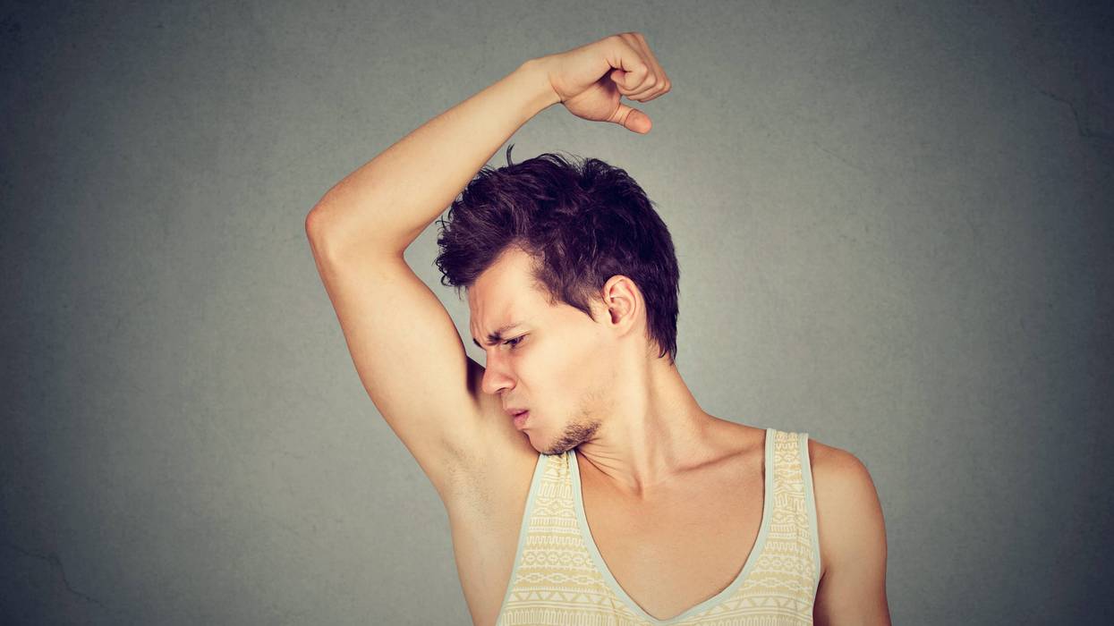 Man smelling his armpit