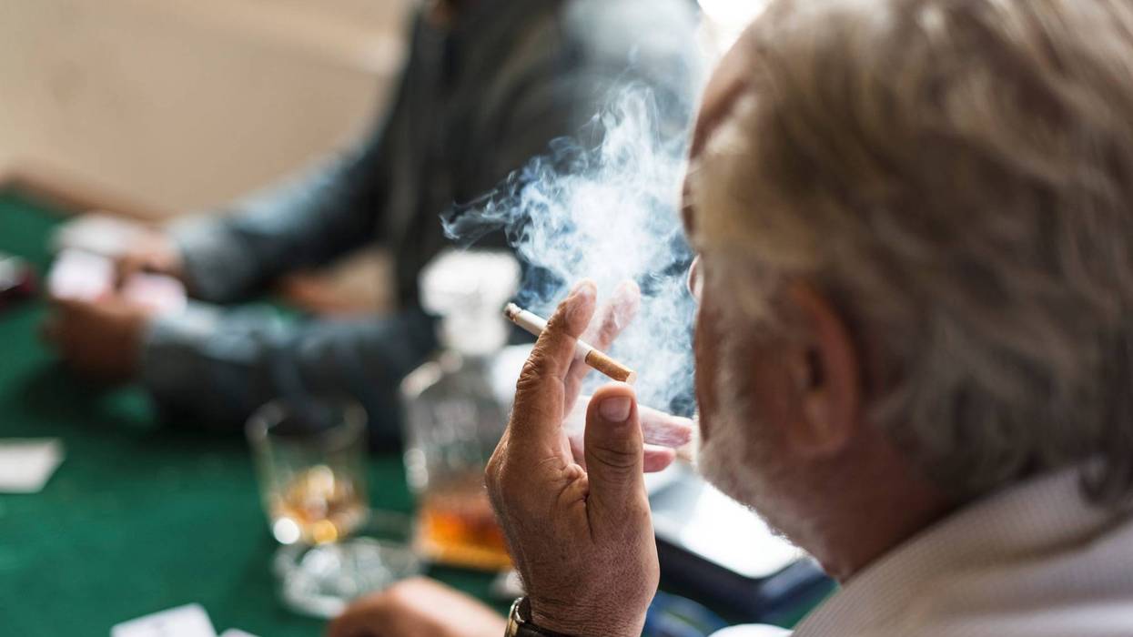 Man smoking while gambling