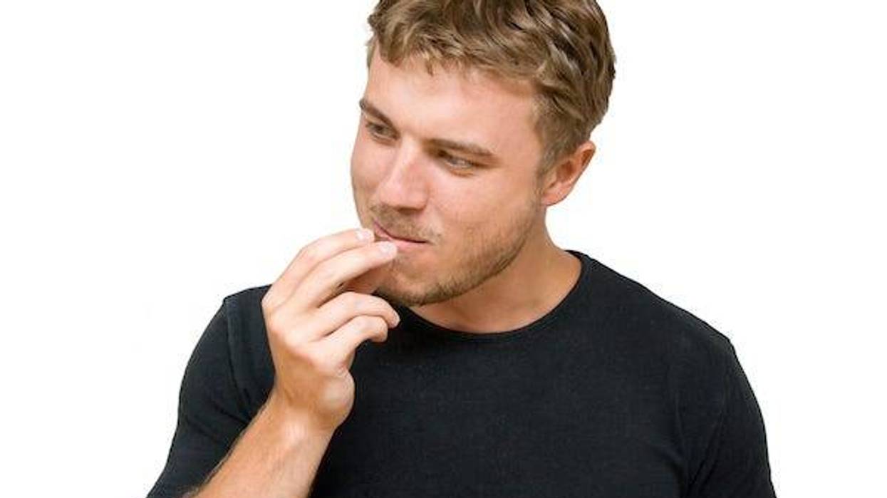 Man sniffing his own fingers