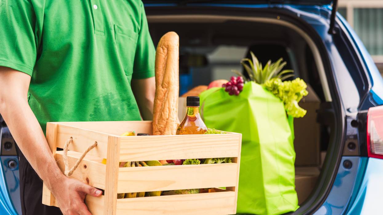 man taking food donations out of car