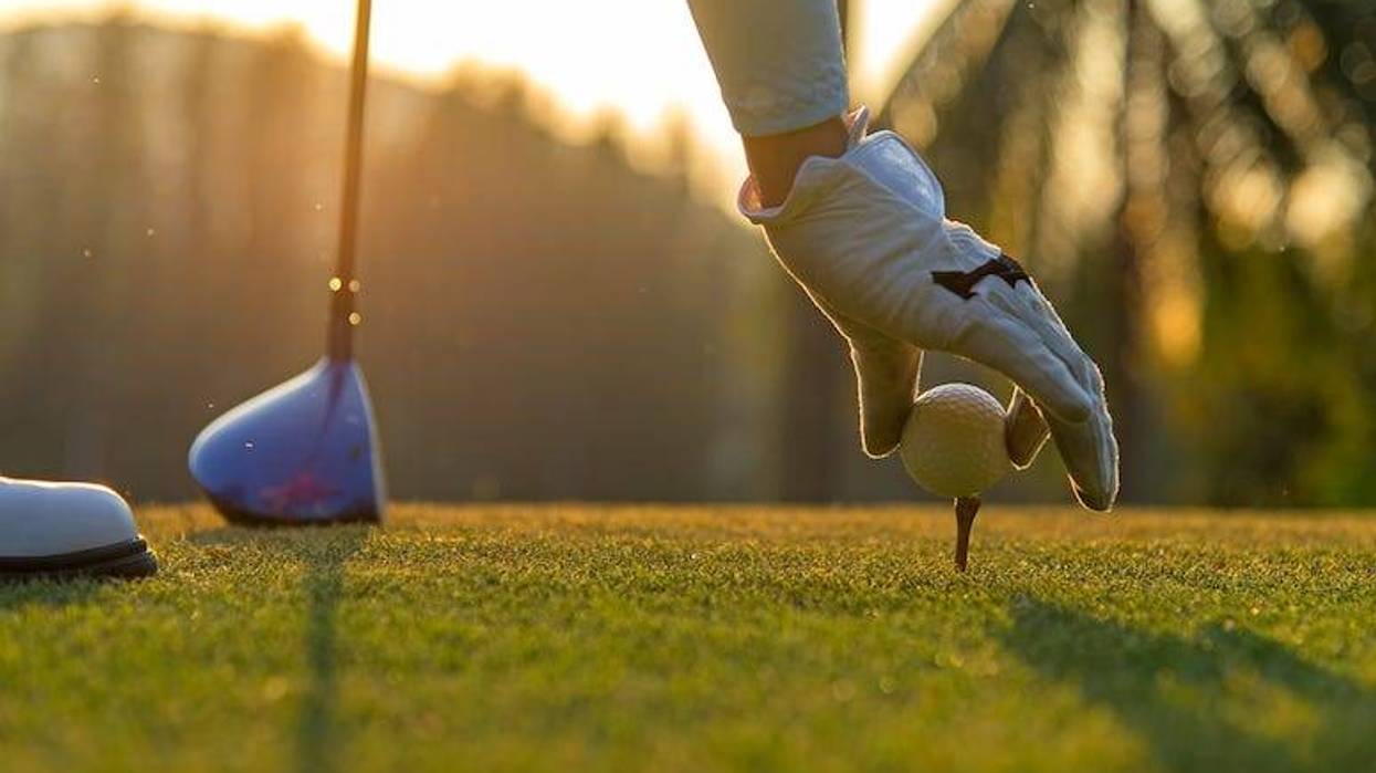 Man teeing up golf shot