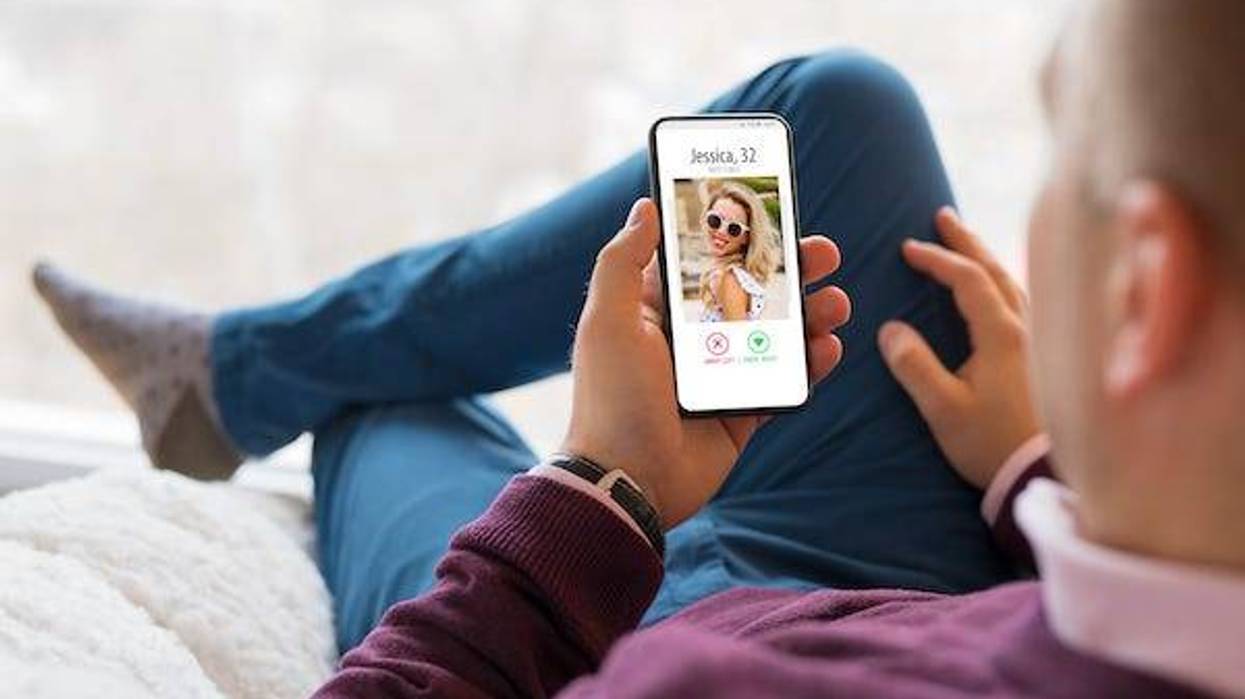 Man using a dating app on a smartphone