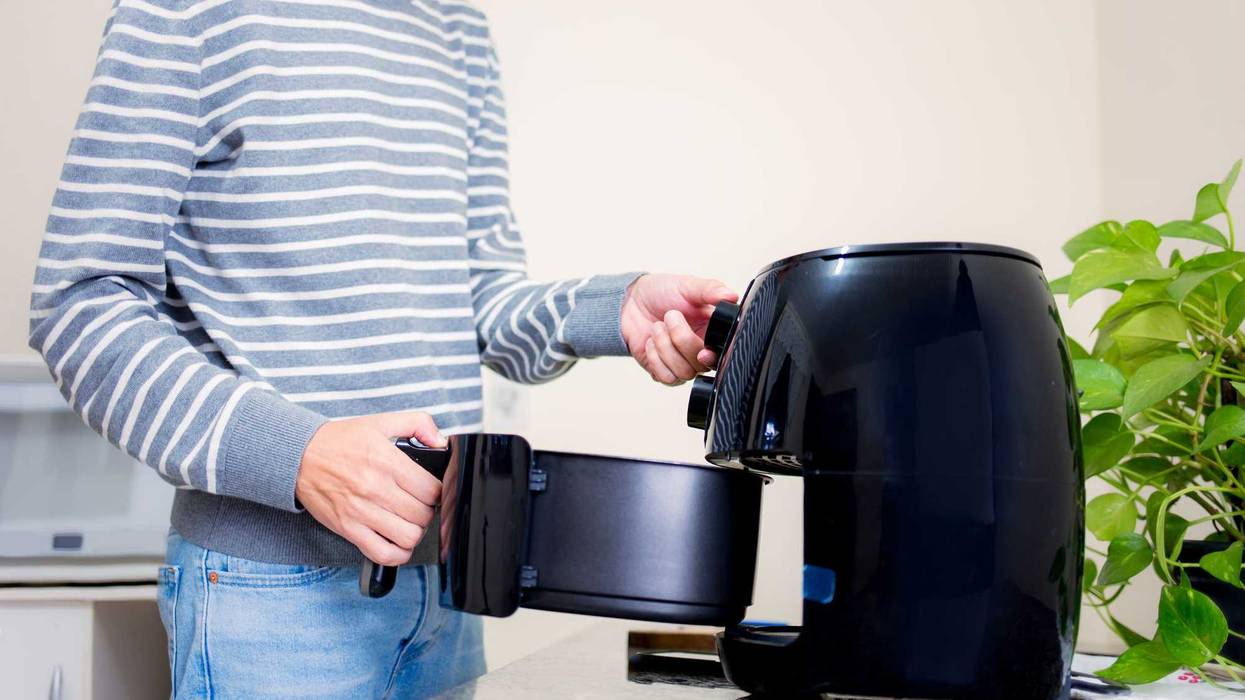 Man using air fryer.