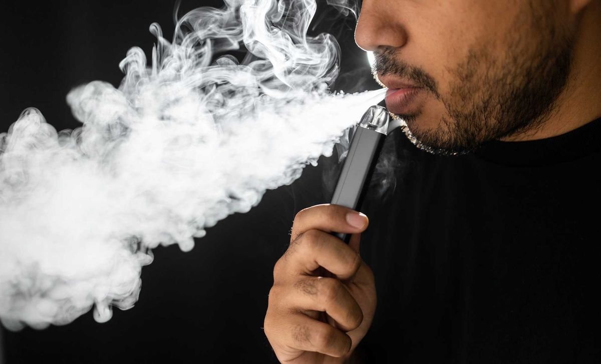 Man using an e-cigarette.