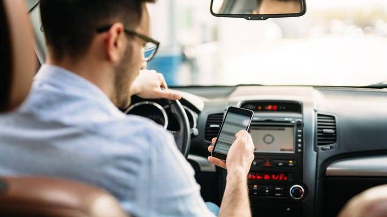Man using phone while driving