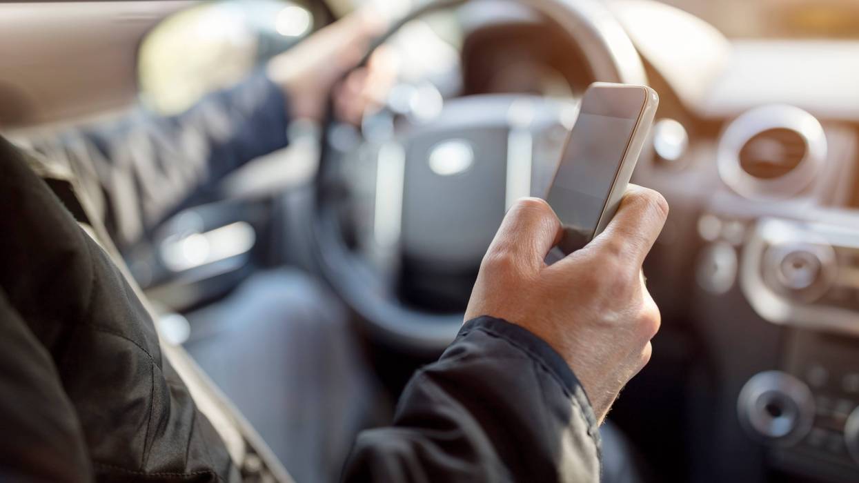 Man using phone while driving