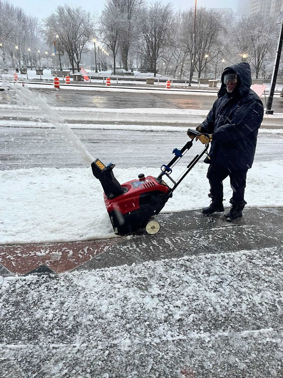 man using snowblower