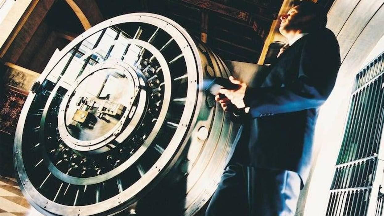 Man walking through a bank vault