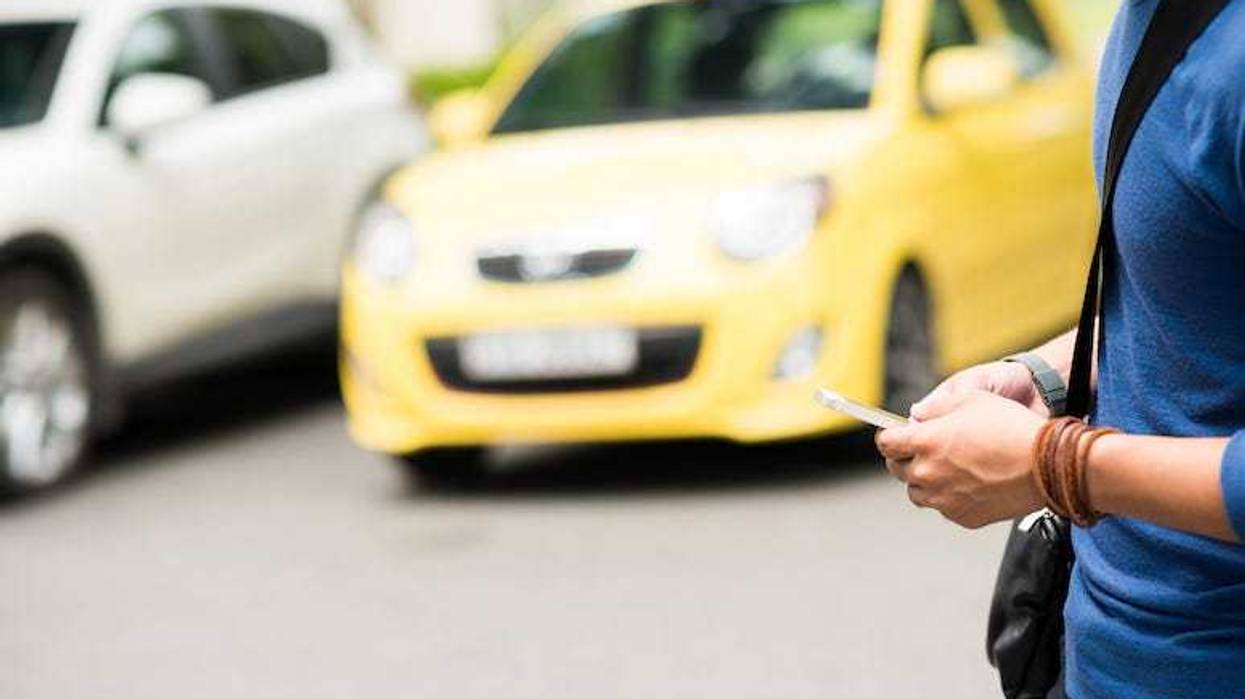 Man walking while texting on phone
