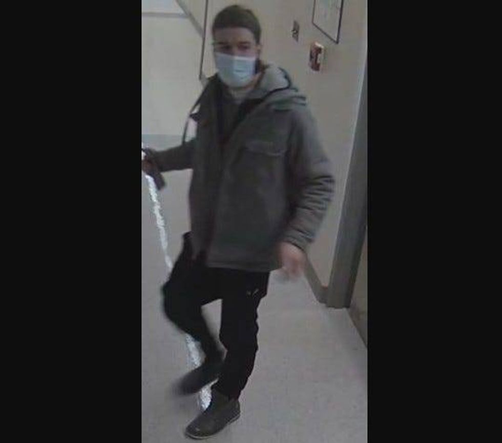 Man wearing black pants and grey coat