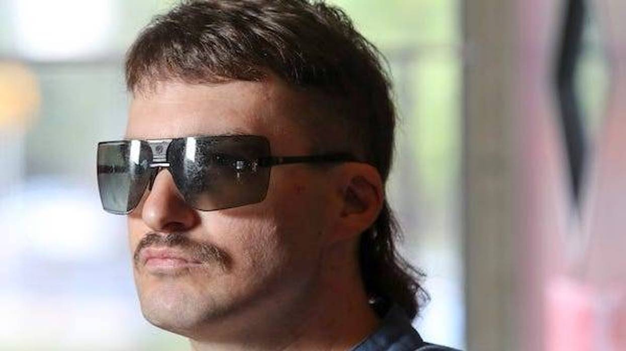 Man with a mullet haircut and sunglasses