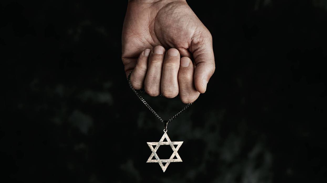 man with a pendant in the shape of the star of david