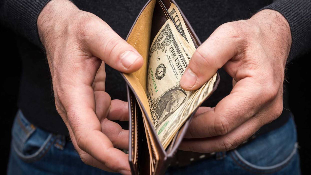 Man with dollar bills in his wallet.