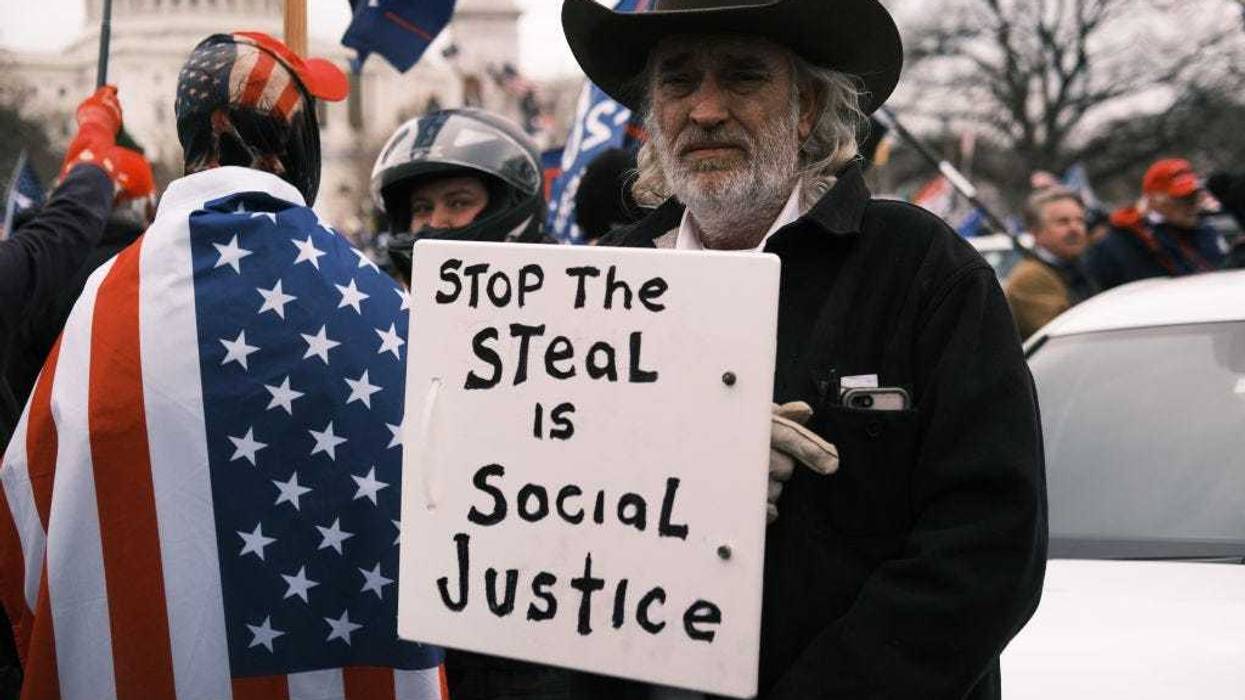 man with stop the steal sign on Jan 6 at the Capitol
