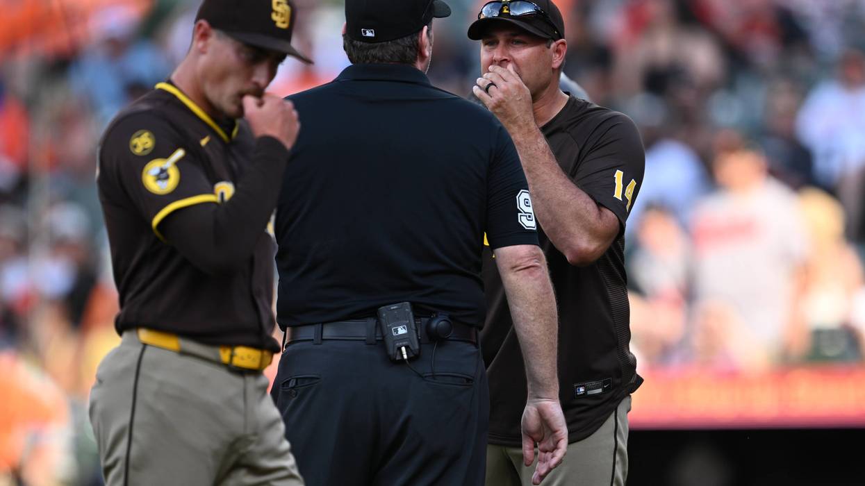 Manager Craig Stammen #14 of the San Diego Padres argues with umpire Chris Conroy #98 after pitcher Ron Marinaccio #97, foreground, is ejected from the game in the ninth inning for hitting a Baltimore Orioles batter at Oriole Park at Camden Yards on June 13, 2026 in Baltimore, Maryland. Stammen was ejected as well moments later.