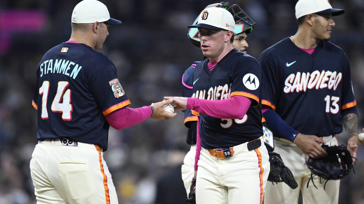 Manager Craig Stammen #14 of the San Diego Padres takes the ball from JP Sears #38 during a pitching change in the fifth inning against the Toronto Blue Jays at Petco Park on July 10, 2026 in San Diego, California