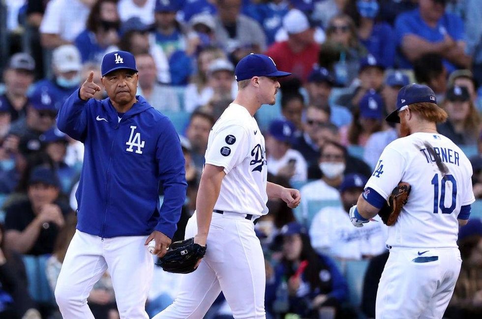 Manager Dave Roberts #30 of the Los Angeles Dodgers relieves pitcher Justin Bruihl #63 during the 6th inning of Game 3.