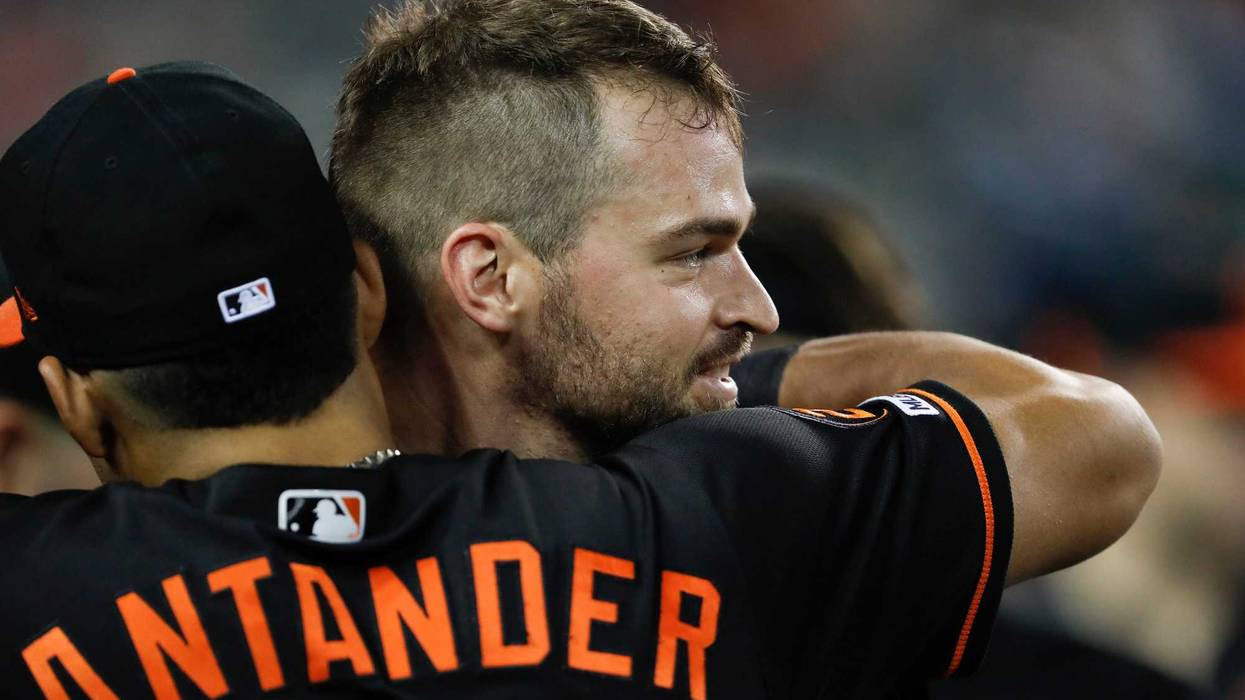 Mancini receives a hug from Santander after hitting a 2-run HR