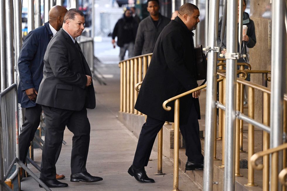 Manhattan District Attorney Alvin Bragg (R) arrives at the Manhattan District Attorney