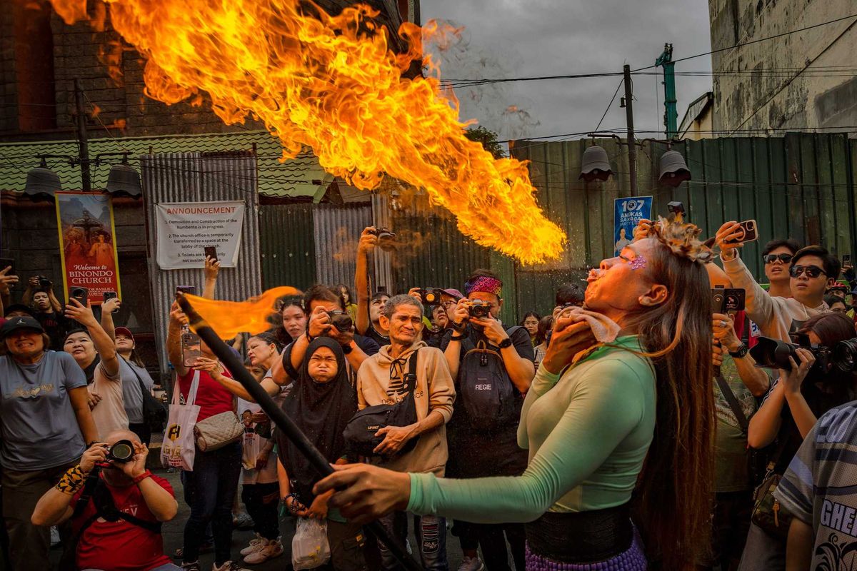 MANILA, PHILIPPINES - JANUARY 29: A performer breathes fire during Lunar New Year celebrations at Binondo district, considered the world's oldest Chinatown, on January 29, 2025 in Manila, Philippines. Chinese New Year, also known as Lunar New Year, will begin on January 29, 2025, marking the Year of the Snake. The celebrations, which last for approximately 15 days, are filled with traditional activities such as family gatherings, lion dances, and the exchange of red envelopes, making it a vibrant cultural event observed by Chinese communities worldwide. (Photo by Ezra Acayan/Getty Images)