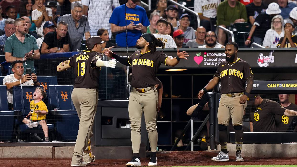 Manny Machado #13 of the San Diego Padres celebrates with Fernando Tatis Jr. #23 after hitting a home run during the ninth inning against the New York Mets at Citi Field on August 18, 2026 in New York City.